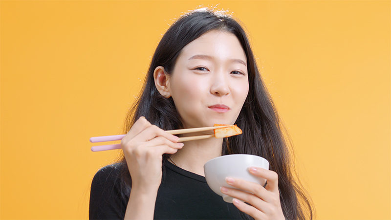 Korean girl smiling eating kimchi  | Vikash Autar Film and Television Director
