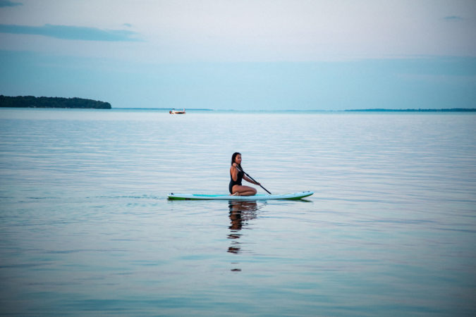 Girl sitting on SUP in Lake Simcoe | Vikash Autar Television Program Film Director Hong Kong and Sydney